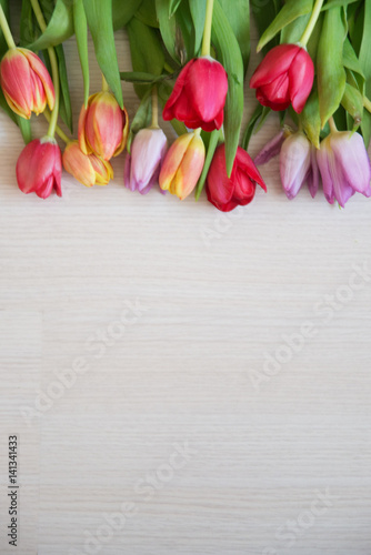 Fototapeta Naklejka Na Ścianę i Meble -  tulips on light wood background