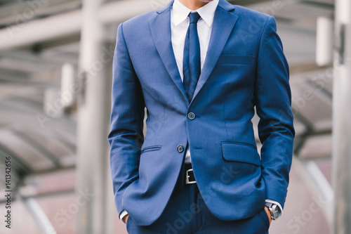 business man hand in pocket with wrist watch in a business suit close up