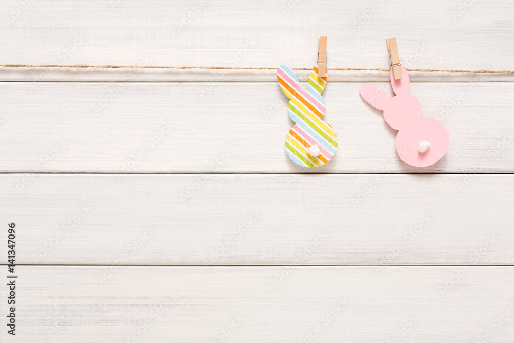 Garland with easter bunnies on white wood background, copy space Garland with easter bunnies on white wood background, copy space
