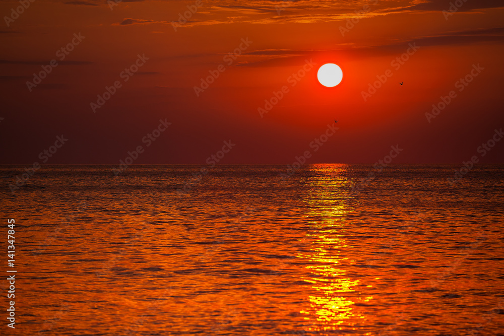 red sunset over water