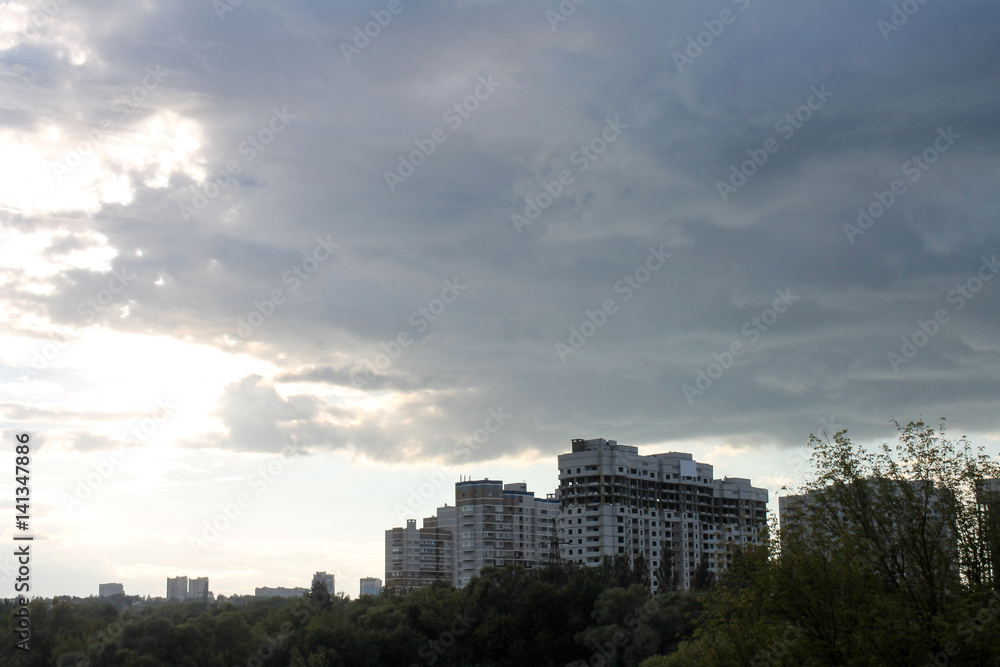 clouds over the city, a view of the construction of multi-storey buildings