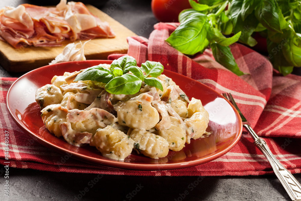 Potato gnocchi, Italian potato dumplings with cheese sauce, ham Potato gnocchi, Italian potato dumplings with cheese sauce, ham