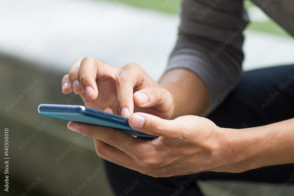 Fototapeta premium man hand holding, using smart phone or smartphone