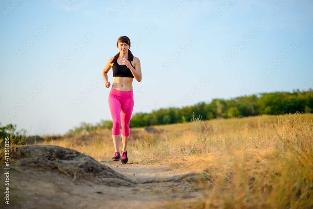 Young Woman Running on the Morning Trail. Active Lifestyle Concept.