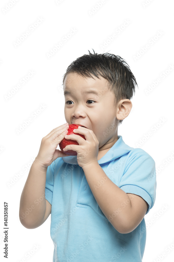 Asian baby boy holding and eating red apple, isolated on white Asian baby boy holding and eating red apple, isolated on white