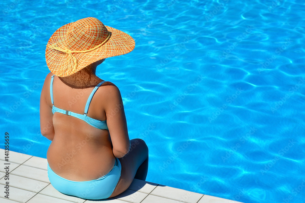 Real pregnant female beauty relaxing at swimming pool