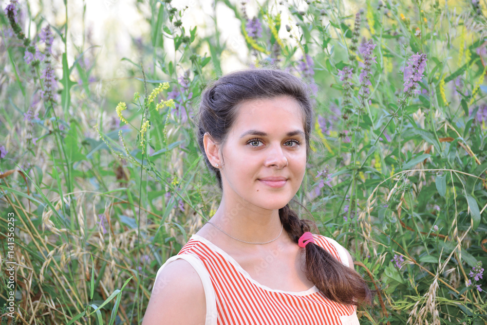Russian girl teenager in background of wildflowers Russian girl teenager in background of wildflowers