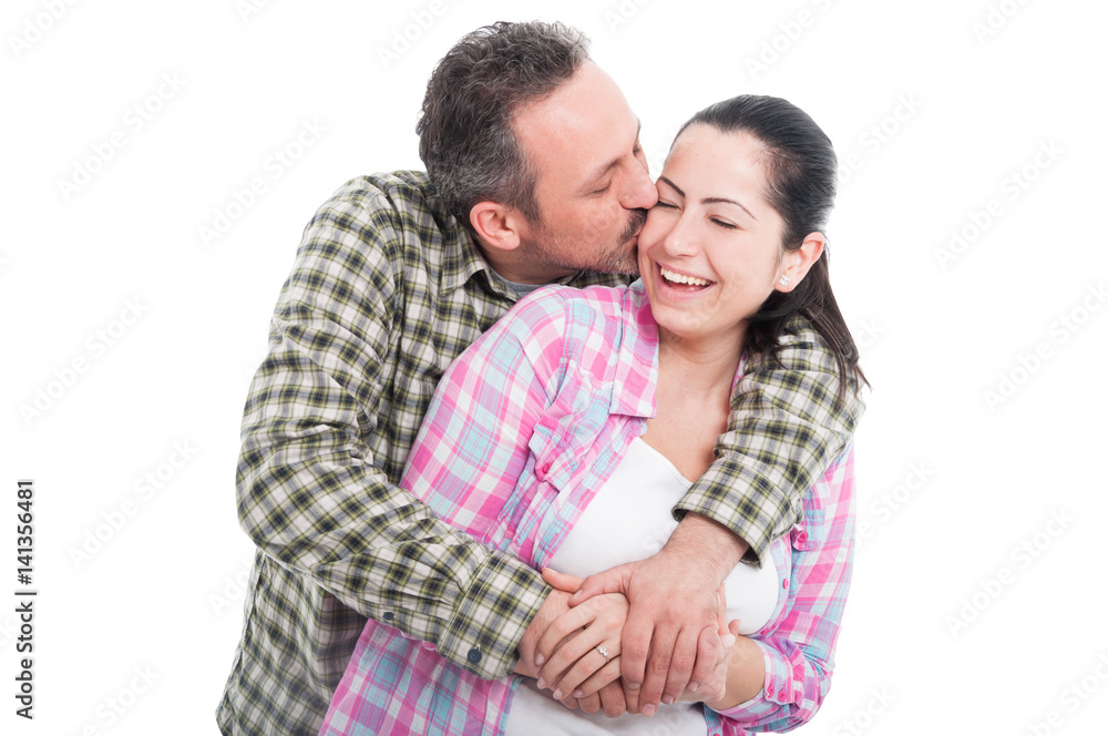 Handsome male embracing and kissing his girlfriend Handsome male embracing and kissing his girlfriend