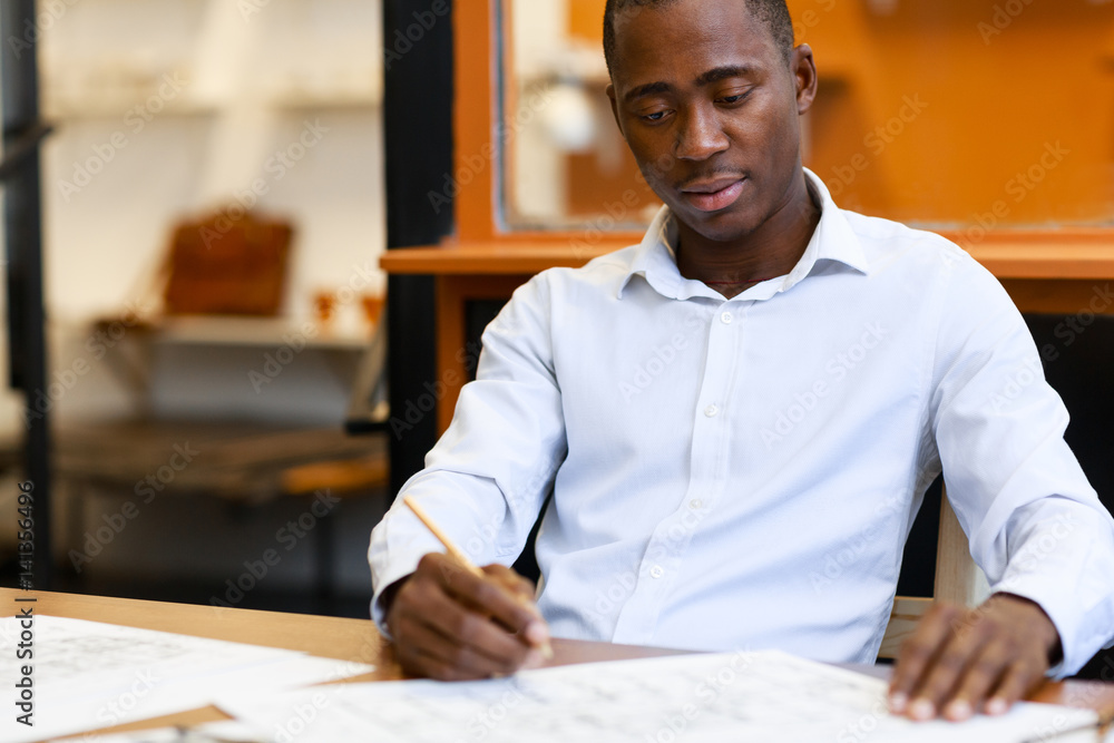 Young technician drawing engineering sketch Young technician drawing engineering sketch