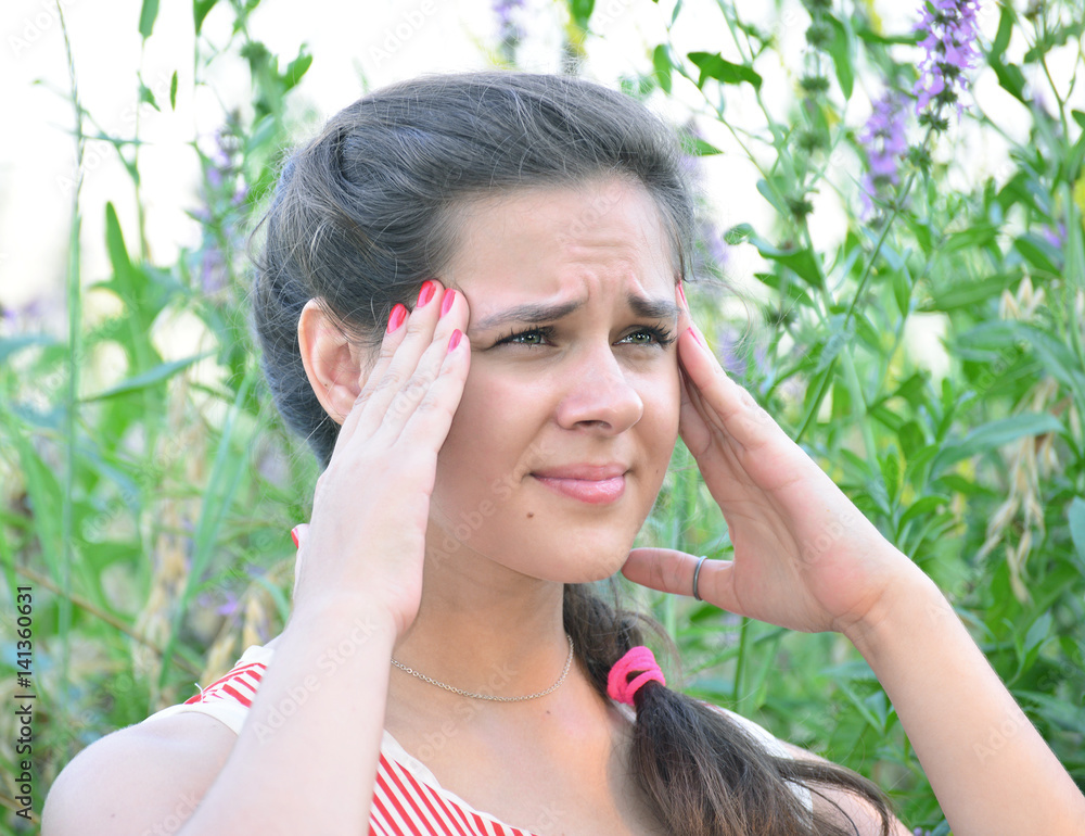 Girl teenager with migraine on nature Girl teenager with migraine on nature