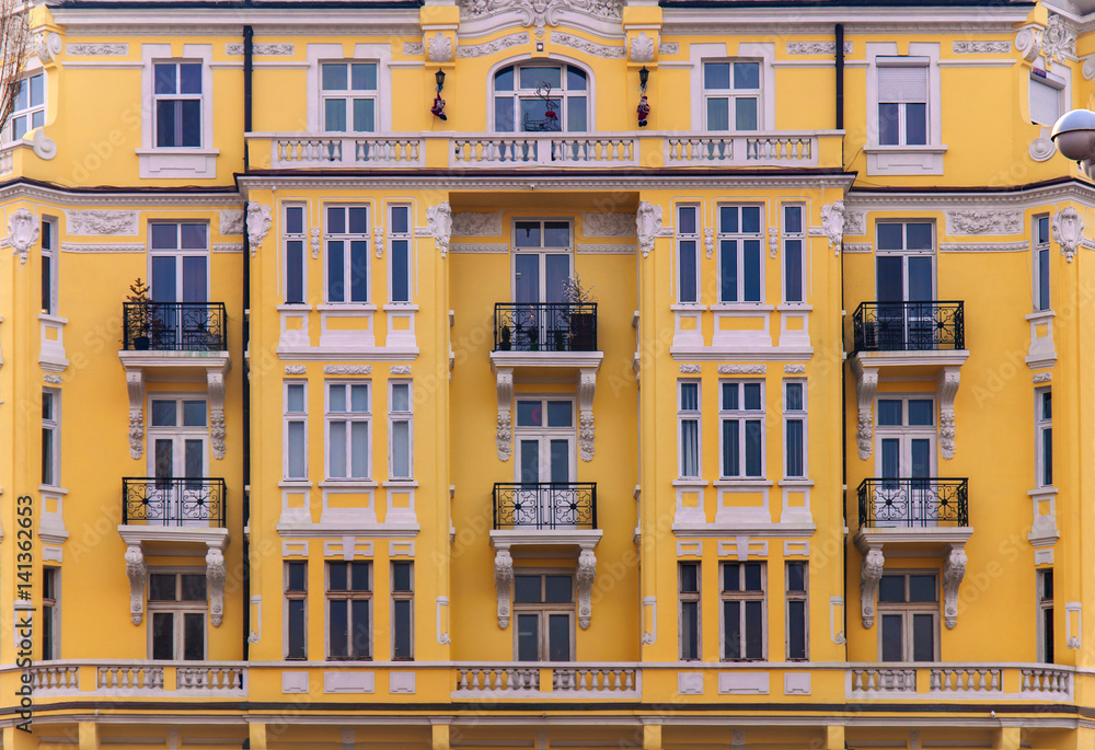 Urban yellow building with blue window