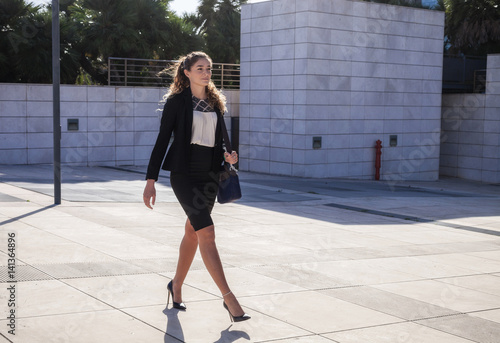 Young businesswoman walking outdoors