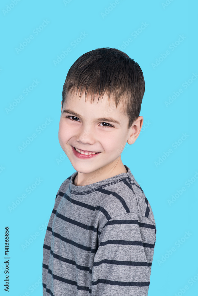 portrait of smiling happy child boy, isolated on blue background portrait of smiling happy child boy, isolated on blue background