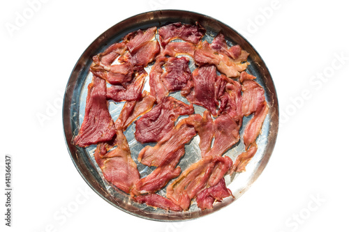 Sun dried pork on stainless tray isolated