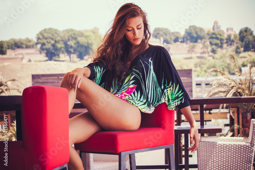 Obraz na plátně summer fashion girl in tunic  and bikini at pool cafe