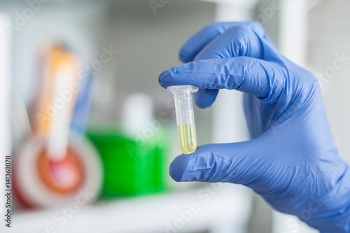 Lab technician holding a test tube with sample