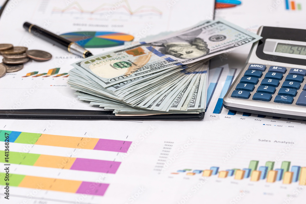 dollar bills, coin on stock chart, calculator and pen. dollar bills, coin on stock chart, calculator and pen.
