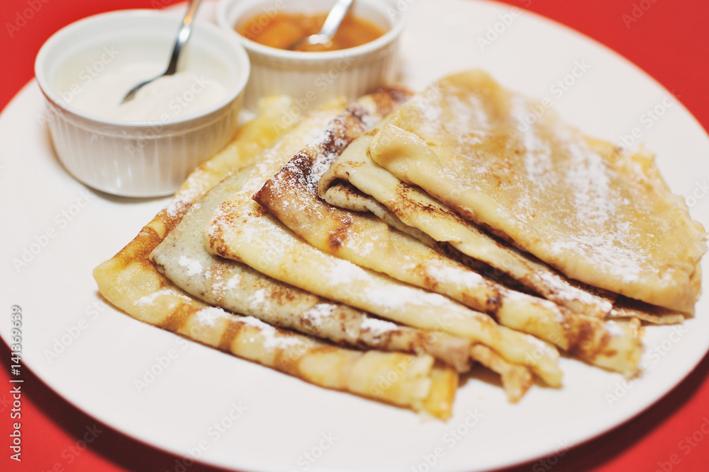Pancakes with jam on a plate close up. Maslenitsa.Shrovetide