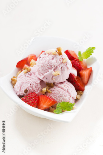 delicious strawberry ice cream in a bowl, vertical