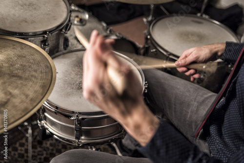 Drummer rolling on snare, closeup, back view, motion blur