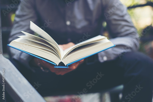 Young man reading book. Learning or Education concept.