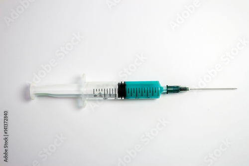 Syringe with blue liquid isolated