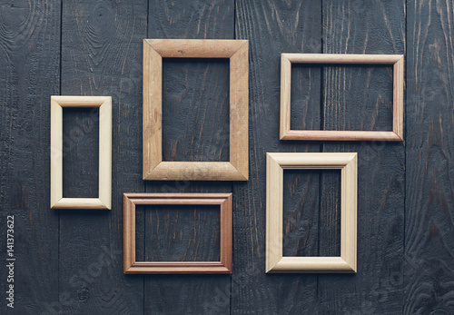 old frames on wooden wall