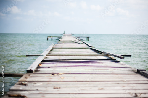Wooden pier on the sea background