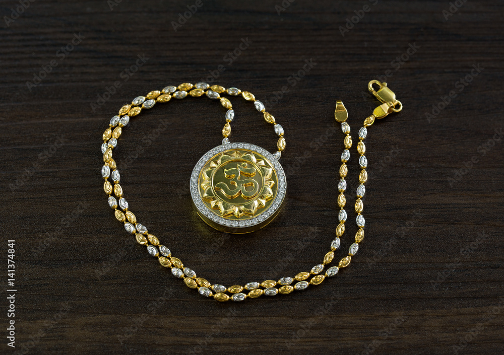 Ganesh spell necklace for good luck on wooden table / Selective focus. Ganesh spell necklace for good luck on wooden table / Selective focus.