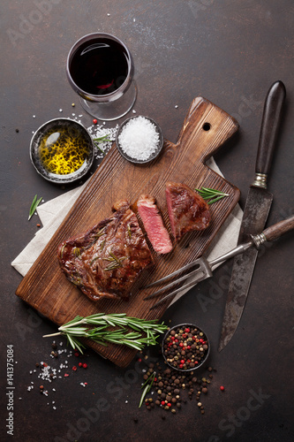 Grilled ribeye beef steak with red wine, herbs and spices
