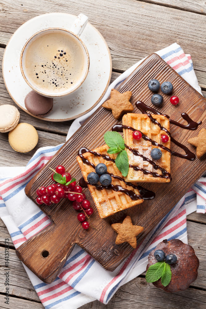 Coffee, sweets and waffles with berries