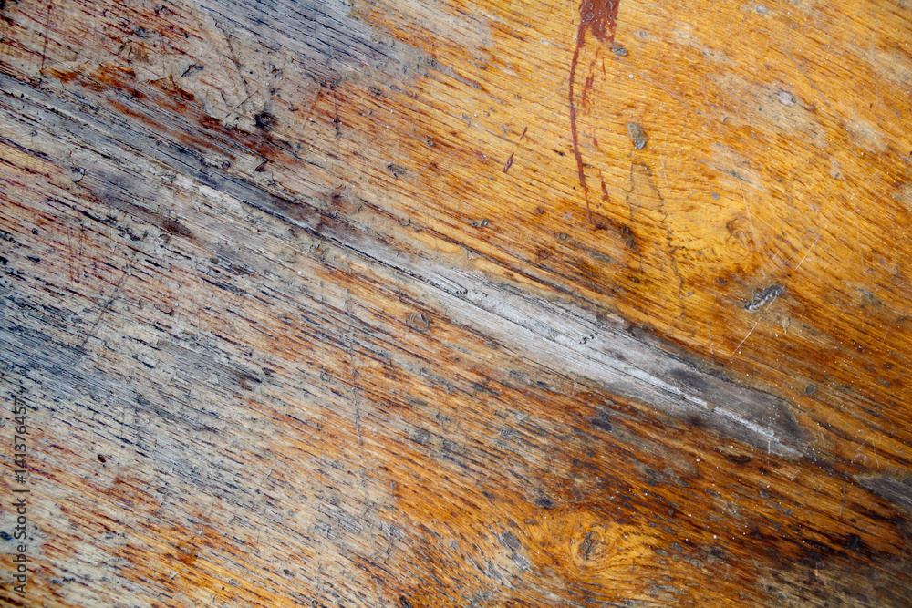 Naklejka premium Fragment of old wooden table with a damaged layer. Abstract background