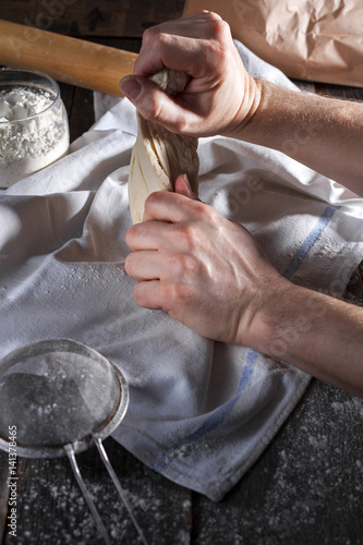 The cook kneads the dough