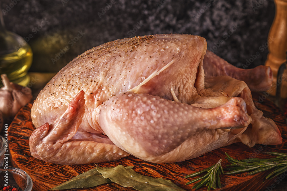 Raw chicken on wooden cutting board Raw chicken on wooden cutting board