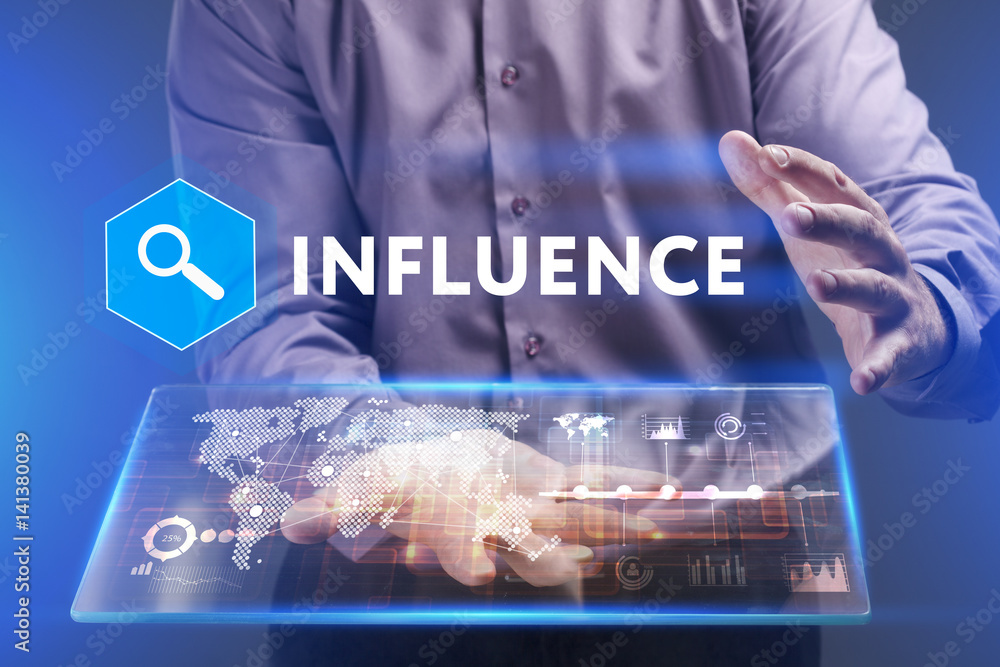 Fototapeta premium Business, Technology, Internet and network concept. Young businessman working on a virtual screen of the future and sees the inscription: Influence