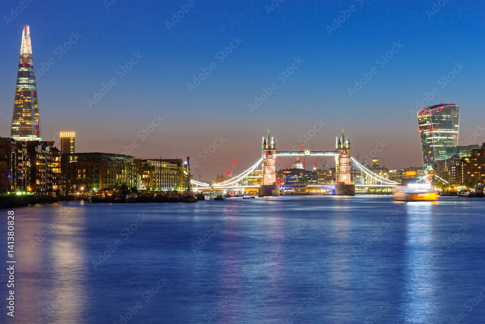 Tower Bridge and cityscape of London at night, UK
