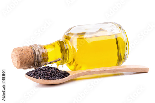 Sesame seeds and oil on white background