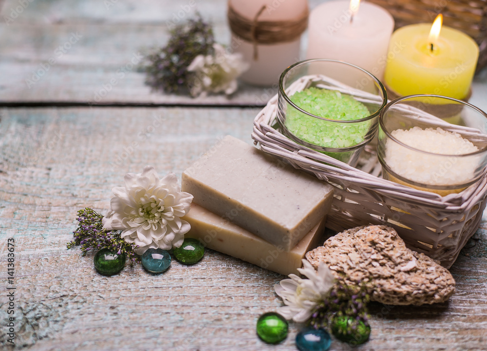 spa setting therapy with flowers, soap, candles isolated on wooden background. spa setting therapy with flowers, soap, candles isolated on wooden background.