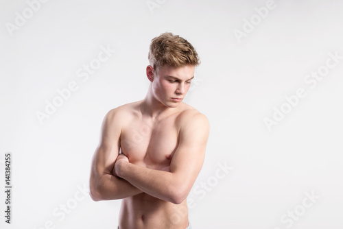 Tableau sur toile Handsome shirtless fitness man, arms crossed. Studio shot.