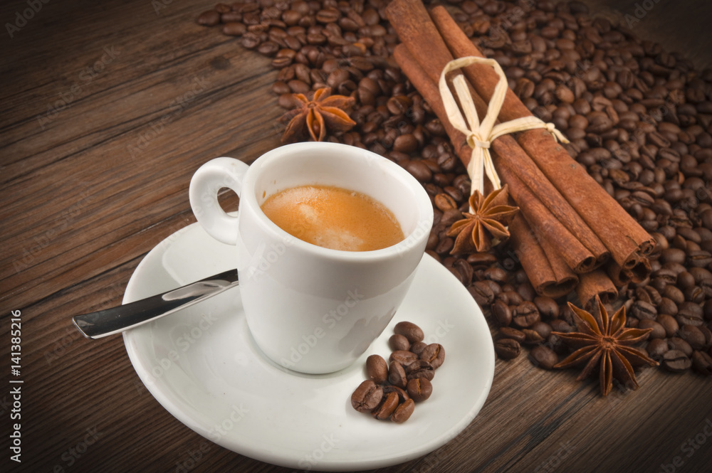 coffee cup with beans on wooden table coffee cup with beans on wooden table