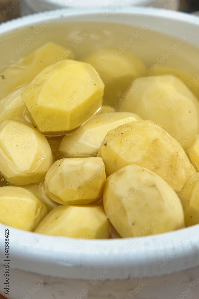Peeled potatoes in a bucket