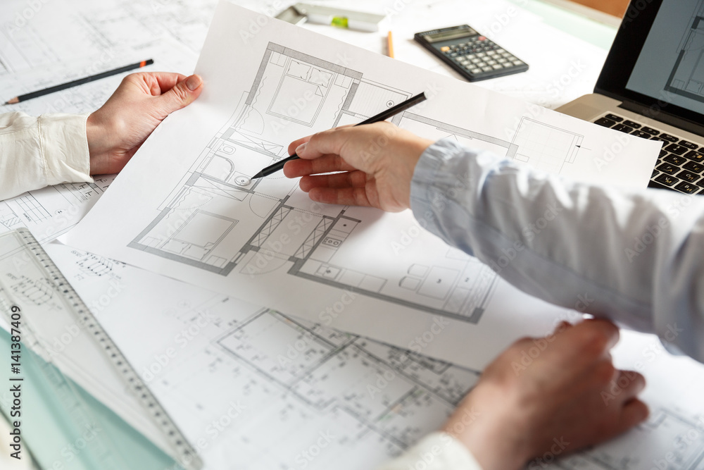 Designers work on a blueprint of new apartments Designers work on a blueprint of new apartments