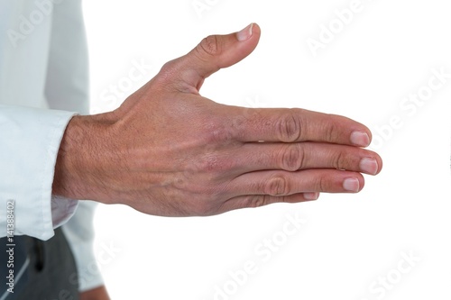 Mid section of executive his hand for offering handshake