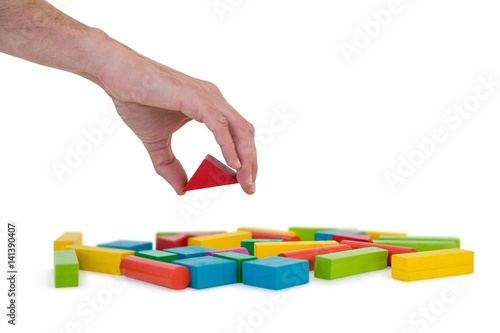 Hand arranging building blocks