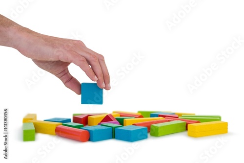 Hand arranging building blocks