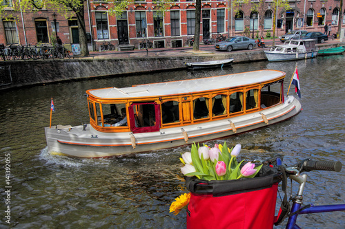 Photography Famous Amsterdam with basket of colorful tulips against boat in Holland