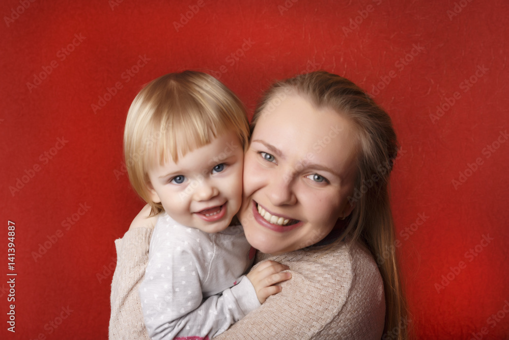 Crazy mother with tiny little blond doughter. Red background. Copy Space. Crazy mother with tiny little blond doughter. Red background. Copy Space.