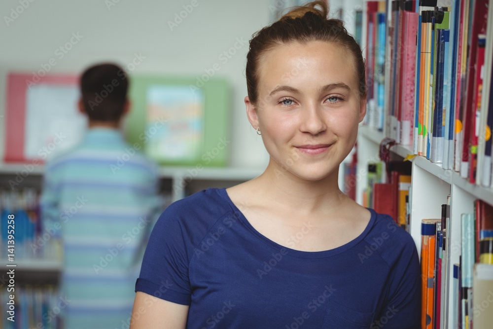 Portrait of smiling schoolgirl smiling in library Portrait of smiling schoolgirl smiling in library
