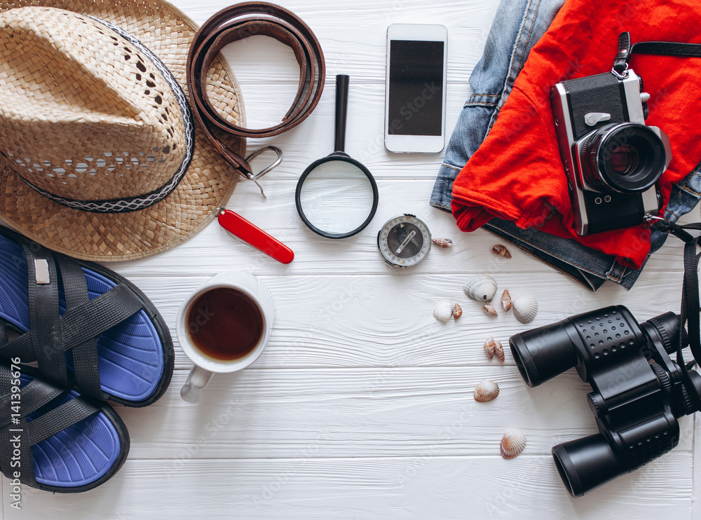 Top view of travel accessories set on white wooden background with copy space Top view of travel accessories set on white wooden background with copy space