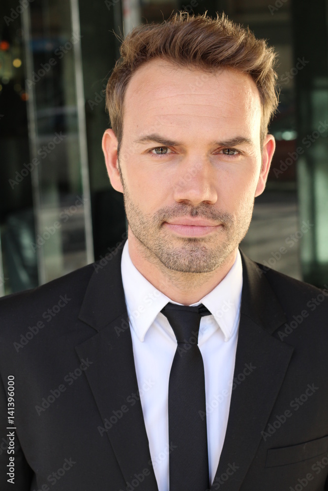 Striking businessman with neutral expression close up Striking businessman with neutral expression close up